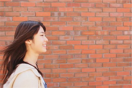 Japanese Teenage Girl Near Bricked Wall Stock Photo - Rights-Managed, Code: 859-03839900