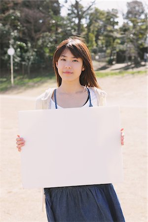 Japanese Girl Holding Whiteboard Stock Photo - Rights-Managed, Code: 859-03839915