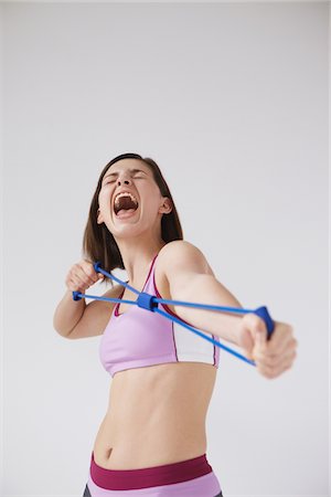 strong human physical strength - Young Woman Stretching Hard Stock Photo - Rights-Managed, Code: 859-03840002