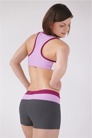 Young Woman Looking Back Hands On Waist Stock Photo - Rights-Managed, Code: 859-03840012