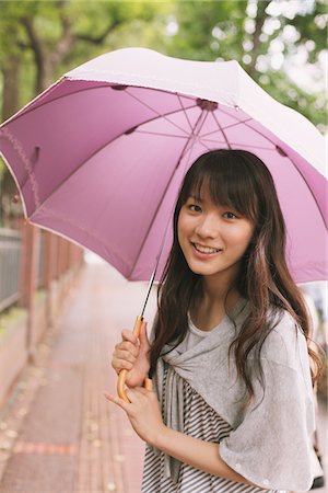 Young adult woman with umbrella Stock Photo - Rights-Managed, Code: 859-03840101