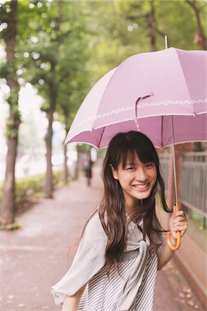 Young adult woman with umbrella Stock Photo - Rights-Managed, Code: 859-03840102