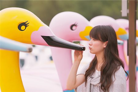 Young adult woman with swan boats Stock Photo - Rights-Managed, Code: 859-03840131