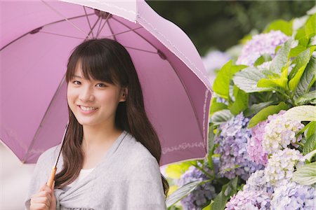Young adult woman with umbrella Stock Photo - Rights-Managed, Code: 859-03840145