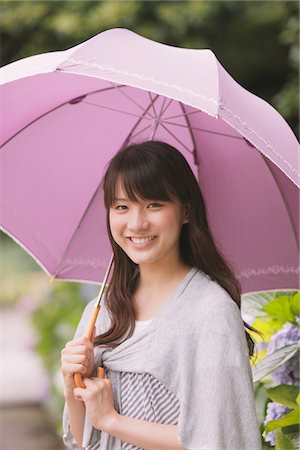 Young adult woman with umbrella Stock Photo - Rights-Managed, Code: 859-03840147