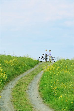 senior couple riding bicycles - Middle-Aged Couple on Tandem Bicycle In Rural Path Stock Photo - Rights-Managed, Code: 859-03840346