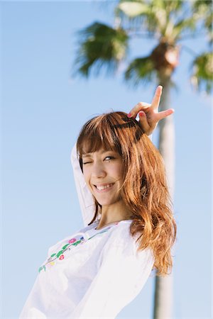 simsearch:859-03840420,k - Young Woman Near A Palm Tree And Blue Sky In Background Stock Photo - Rights-Managed, Code: 859-03840417