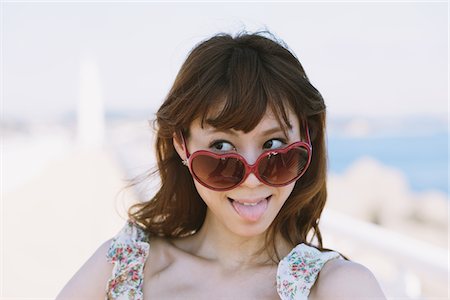 eyeglasses detail - Happy Cheerful Young Woman Sticking Tongue Out Stock Photo - Rights-Managed, Code: 859-03840411