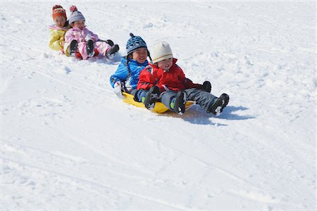 snow sledge - Children Sledging In Snow Stock Photo - Rights-Managed, Code: 859-03840697