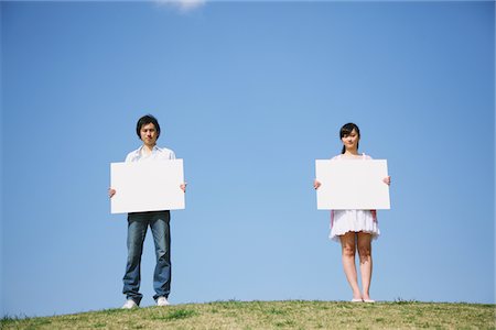 Young adult couple Holding Whiteboard Stock Photo - Rights-Managed, Code: 859-03840843
