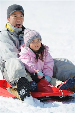 Father And Daughter sledging In Snow Stock Photo - Rights-Managed, Code: 859-03840992