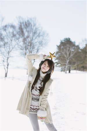 earmuffs - Teenage Girl Holding Star Over Her Head Stock Photo - Rights-Managed, Code: 859-03860631