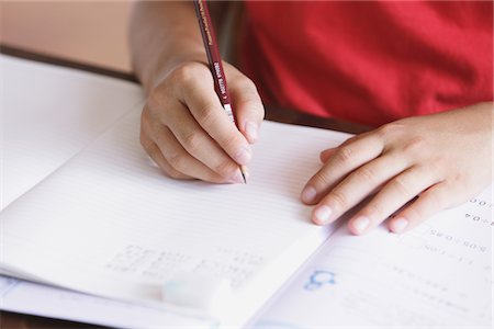 Student Writing In Notebook Foto de stock - Con derechos protegidos, Código: 859-03860800