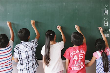 Students Writing On Chalkboard Together Stock Photo - Rights-Managed, Code: 859-03860816