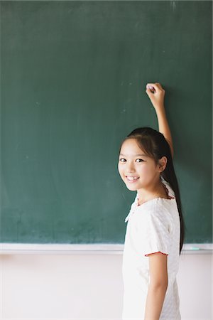 study (room) - Schoolgirl Writing On Chalkboard Stock Photo - Rights-Managed, Code: 859-03860818