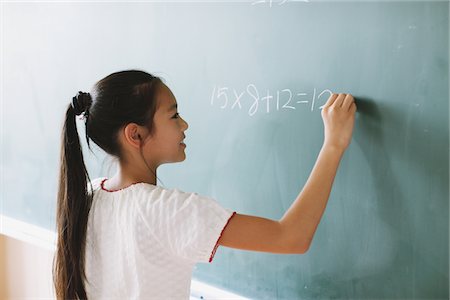 Schoolgirl Solving Math Problem Foto de stock - Con derechos protegidos, Código: 859-03860824