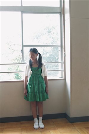 sad asian child - Girl Standing In Classroom Window In Background Stock Photo - Rights-Managed, Code: 859-03860971