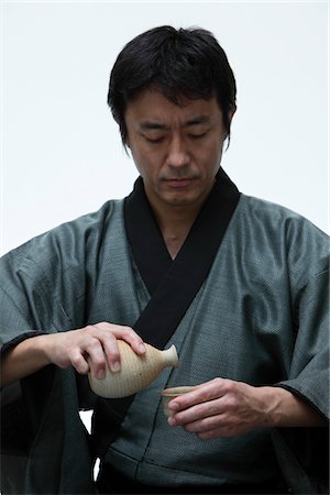 Japanese man holding a Sake bottle Stock Photo - Rights-Managed, Code: 859-03884612