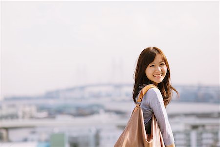 simsearch:622-06190754,k - Young Japanese Women Smiling And Carrying Handbag Stock Photo - Rights-Managed, Code: 859-03885286