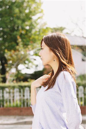 Japanese Young Woman Walking Outdoors, Side View Stock Photo - Rights-Managed, Code: 859-03885314