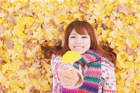 Japanese Women Lying On Ginkgo Leaves And Holding Leaf Stock Photo - Rights-Managed, Code: 859-03885461