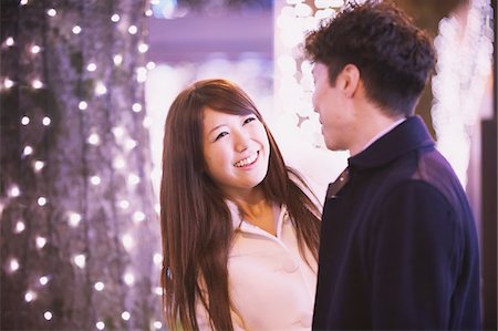 festive lights at night - Japanese Couple Smiling And Looking At Each Other Stock Photo - Rights-Managed, Code: 859-03982555