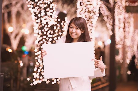 sidewalk blur - Japanese Women Holding Whiteboard And Pointing Stock Photo - Rights-Managed, Code: 859-03982566