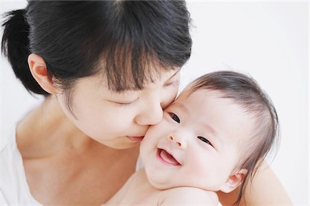 simsearch:859-03982679,k - Mother Kissing Her Smiling Baby Stock Photo - Rights-Managed, Code: 859-03982718