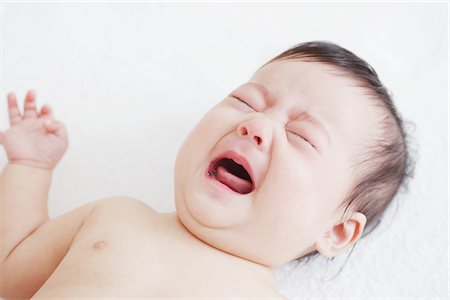 sad person laying down - Baby Girl Crying Stock Photo - Rights-Managed, Code: 859-03982711
