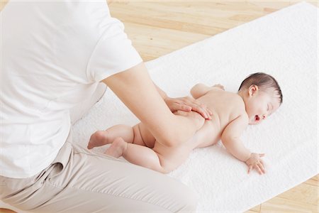 Mother Massaging Baby Stock Photo - Rights-Managed, Code: 859-03982728