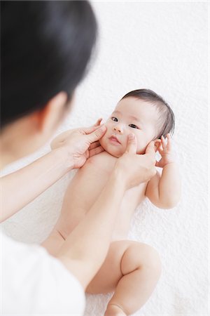 exercise indoors smile asian - Mother Touching Baby's Face Stock Photo - Rights-Managed, Code: 859-03982734