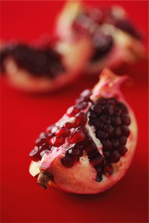 pomegranates not people not illustration - Slices Of Pomegranate On Red Background Stock Photo - Rights-Managed, Code: 859-03983064