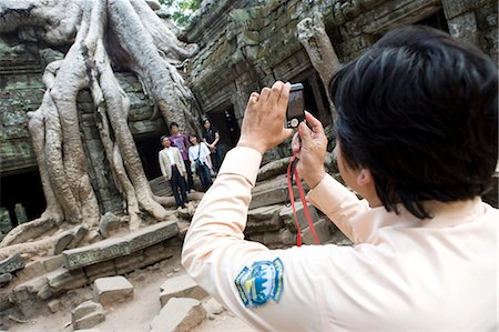 Woman taking photo group of people at temple of Ta Prohm,Siem Reap,Cambodia Stock Photo - Rights-Managed, Code: 851-02959016
