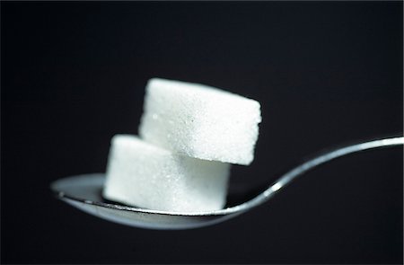 Detail of sugar cubes on spoon Foto de stock - Direito Controlado, Número: 851-02959483