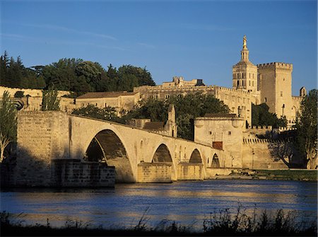 palace of the popes at avignon - Looking along the Pont d'Avignon or Pont St Benezet towards the Palais des Papes (Palace of the Popes) and the Cathedrale Notre-Dame-des-Doms in the early evening,Avignon,France. Stock Photo - Rights-Managed, Code: 851-02959790