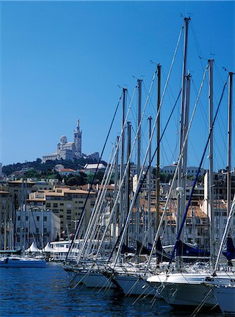 Looking over yacht masts and across the harbour to the Notre Dame de la Garde cathedral,Marseille,France. Stock Photo - Rights-Managed, Code: 851-02959915