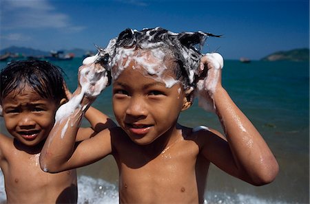 photos beach boys in asia - Washing hair in the sea near Nha Trang,Vietnam Stock Photo - Rights-Managed, Code: 851-02964449