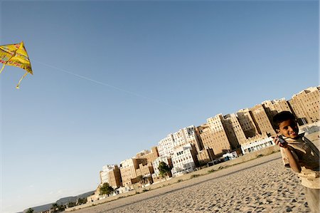 Boy flying kite by walls of Shibam,Hadramawt valley,Yemen Stock Photo - Rights-Managed, Code: 851-02964460