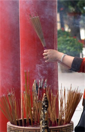 Woman holding bunch of smoking incense sticks at Wong Tai Sin Temple,Hong Kong,China Stock Photo - Rights-Managed, Code: 851-02960147