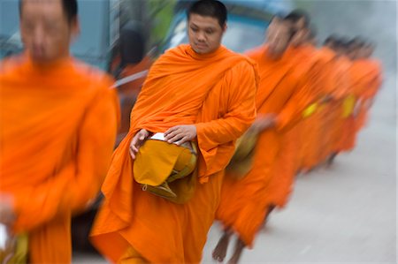 simsearch:851-02964431,k - Novice monks out collecting alms at dawn,Luang Prabang,Northern Laos (UNESCO World Heritage Site) Stock Photo - Rights-Managed, Code: 851-02961353