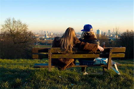 Couple sitting on bench on Parliament Hill,Hamstead Heath,London,UK Stock Photo - Rights-Managed, Code: 851-02961494