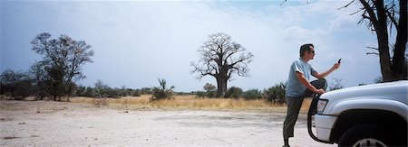 Using mobile phone in desert,Caprivi,Namibia Stock Photo - Rights-Managed, Code: 851-02962308