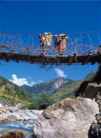 porter - Crossing suspension bridge,Gurung Porters,Dhaulagiri Region,Nepal Stock Photo - Rights-Managed, Code: 851-02962325