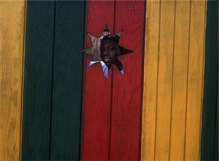 federation of st kitts and nevis - Boy looking through hole in wall,Pinneys Beach,Nevis Stock Photo - Rights-Managed, Code: 851-02962379