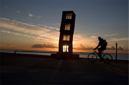 Silhouette of cyclist passing sculpture,Barcelona,Catalonia,Spain Stock Photo - Rights-Managed, Code: 851-02963075