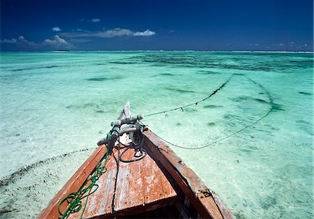 simsearch:851-02963318,k - Old boat sitting in the shallow water off Matemwe on the north east coast of Zanzibar,Tanzania. Stock Photo - Rights-Managed, Code: 851-02963345