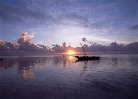 Dhow in calm waters at low tide at dawn,Matemwe beach,Zanzibar,Tanzania. Stock Photo - Rights-Managed, Code: 851-02963364
