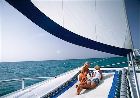 sun bather - Couple relaxing on catamaran,Providenciales,Turks & Caicos Islands Stock Photo - Rights-Managed, Code: 851-02963367