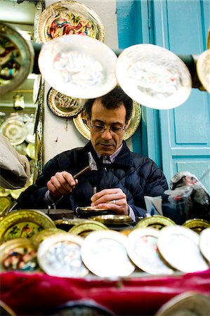 Craftsman carving on brass plates,Central Medina / Souq,Tunis,Tunisia,North Africa Stock Photo - Rights-Managed, Code: 851-02963588