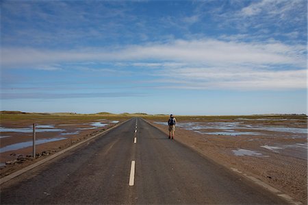 puddle road - Person walking along road in Lindisfarne,England,UK Stock Photo - Rights-Managed, Code: 851-02963889